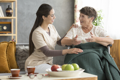 happy senior woman talking to a caregiver