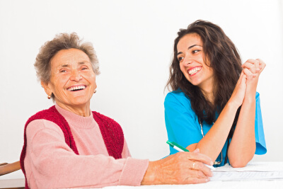 happy senior woman with her caregiver